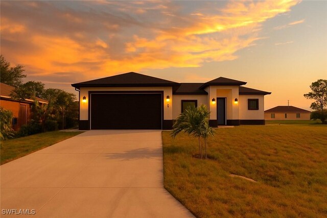 2933 20th St SW, Lehigh Acres, FL 33976 - prairie-style house with concrete driveway, a garage, stucco siding, and a yard
