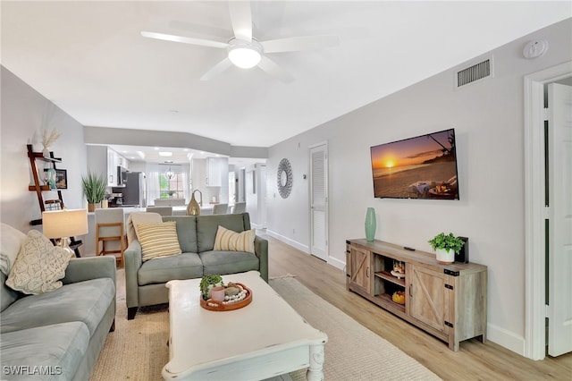 773 Wiggins Lake Dr Unit 101, Naples, FL 34110 - living room with light wood finished floors, a ceiling fan, and baseboards