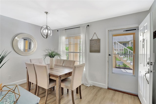 773 Wiggins Lake Dr Unit 101, Naples, FL 34110 - dining area with a chandelier, baseboards, and light wood-type flooring