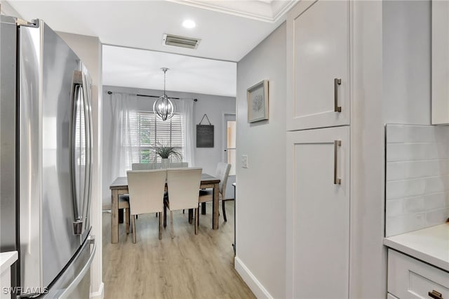 773 Wiggins Lake Dr Unit 101, Naples, FL 34110 - dining area featuring a chandelier, light wood finished floors, and baseboards