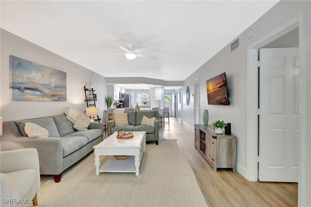773 Wiggins Lake Dr Unit 101, Naples, FL 34110 - living area with ceiling fan, light wood-style flooring, and baseboards
