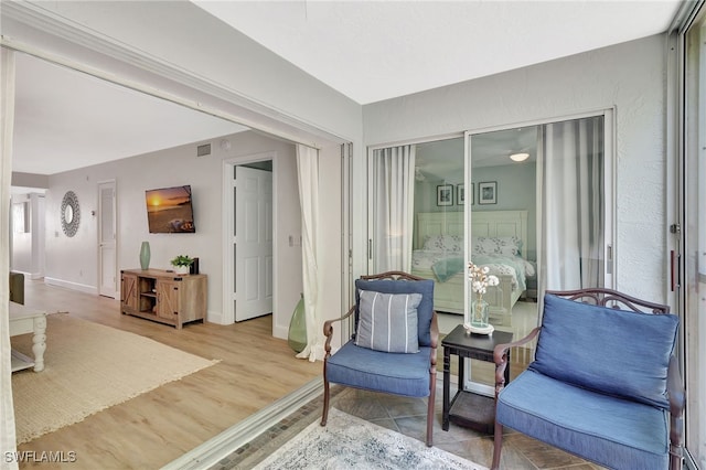 773 Wiggins Lake Dr Unit 101, Naples, FL 34110 - sitting room with baseboards and wood finished floors