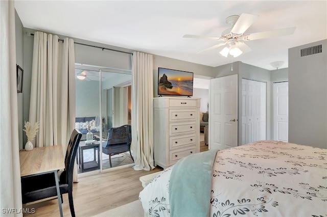 773 Wiggins Lake Dr Unit 101, Naples, FL 34110 - bedroom featuring light wood-style floors, multiple closets, access to outside, and a ceiling fan