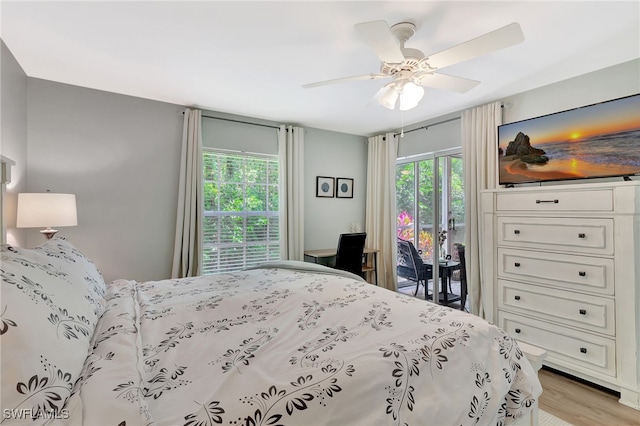 773 Wiggins Lake Dr Unit 101, Naples, FL 34110 - bedroom with access to outside, light wood-style floors, and ceiling fan