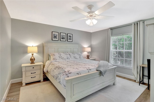 773 Wiggins Lake Dr Unit 101, Naples, FL 34110 - bedroom featuring baseboards, light wood-style flooring, and ceiling fan