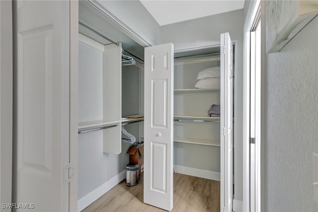 773 Wiggins Lake Dr Unit 101, Naples, FL 34110 - walk in closet with wood finished floors