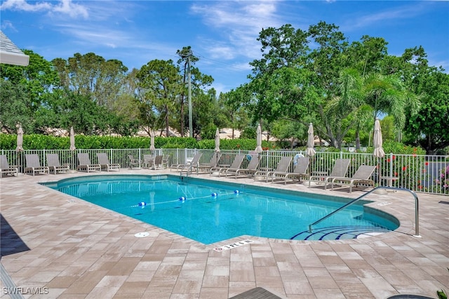 773 Wiggins Lake Dr Unit 101, Naples, FL 34110 - community pool with a patio area and view of scattered trees