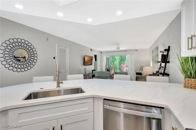 773 Wiggins Lake Dr Unit 101, Naples, FL 34110 - kitchen with dishwasher, a sink, white cabinetry, light stone countertops, and recessed lighting