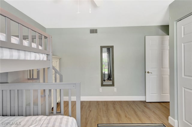 773 Wiggins Lake Dr Unit 101, Naples, FL 34110 - bedroom with wood finished floors and baseboards