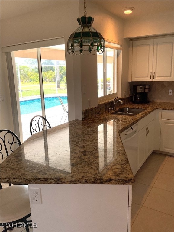 86 Pinehurst Pl, Rotonda West, FL 33947 - kitchen featuring a sink, dishwasher, white cabinetry, and plenty of natural light