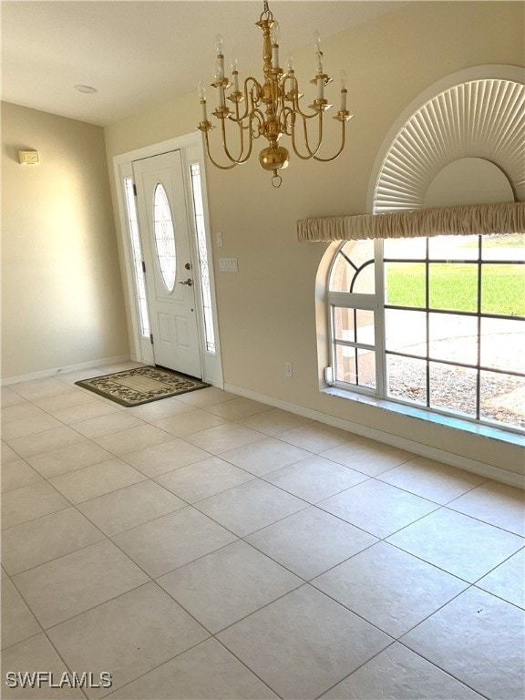 86 Pinehurst Pl, Rotonda West, FL 33947 - foyer entrance featuring light tile patterned flooring, baseboards, and a chandelier