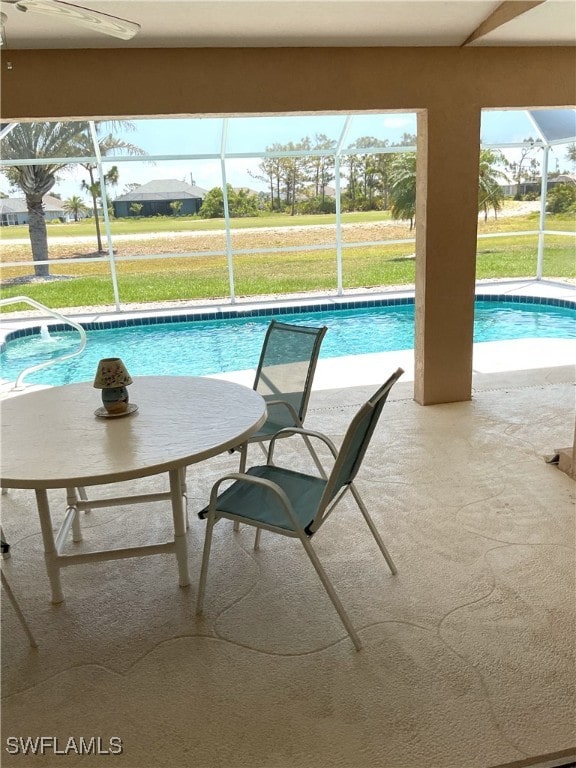 86 Pinehurst Pl, Rotonda West, FL 33947 - outdoor pool featuring glass enclosure, a patio area, and a lawn