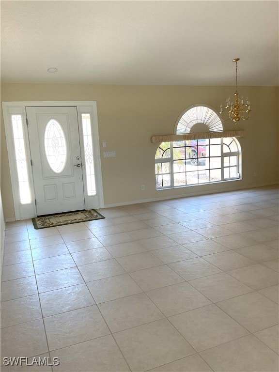 86 Pinehurst Pl, Rotonda West, FL 33947 - entrance foyer with light tile patterned floors, a chandelier, and baseboards