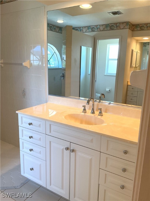86 Pinehurst Pl, Rotonda West, FL 33947 - bathroom featuring vanity and tile patterned floors