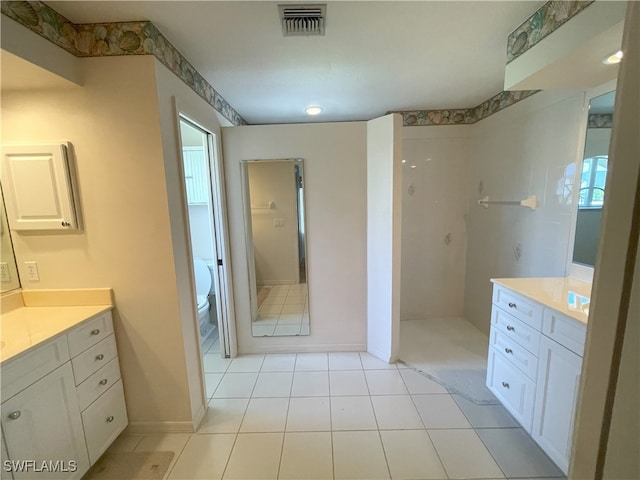 86 Pinehurst Pl, Rotonda West, FL 33947 - bathroom featuring vanity, walk in shower, toilet, and tile patterned floors