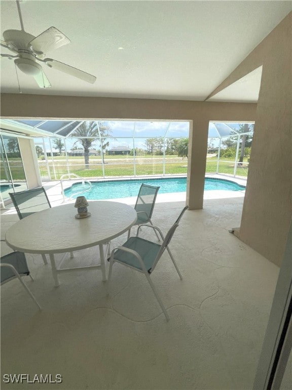 86 Pinehurst Pl, Rotonda West, FL 33947 - swimming pool featuring glass enclosure, a ceiling fan, a patio, and a yard