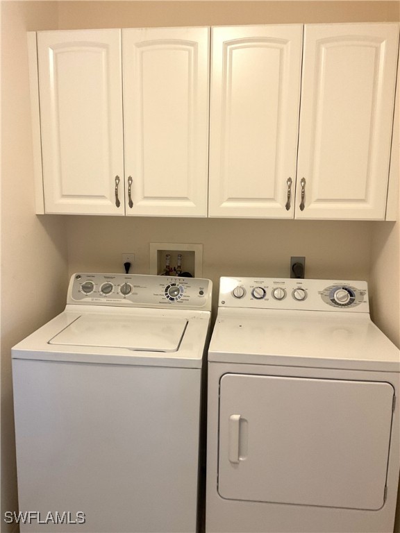 86 Pinehurst Pl, Rotonda West, FL 33947 - laundry room featuring washing machine and clothes dryer and cabinet space