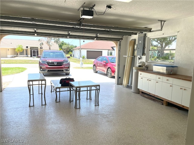 86 Pinehurst Pl, Rotonda West, FL 33947 - garage with a garage door opener and electric panel