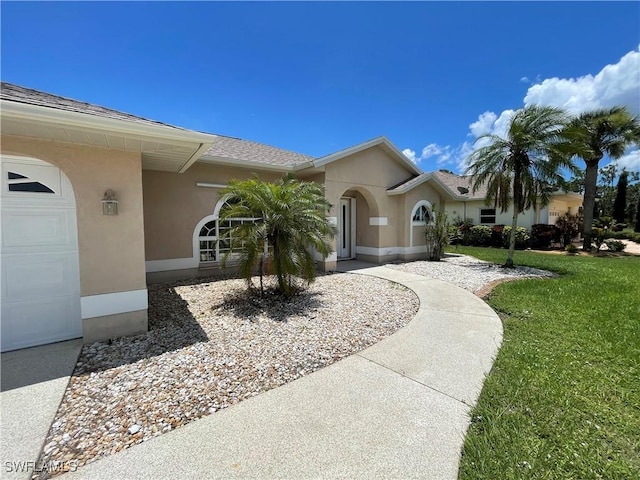 86 Pinehurst Pl, Rotonda West, FL 33947 - view of front of house with stucco siding, a front lawn, a garage, and a shingled roof