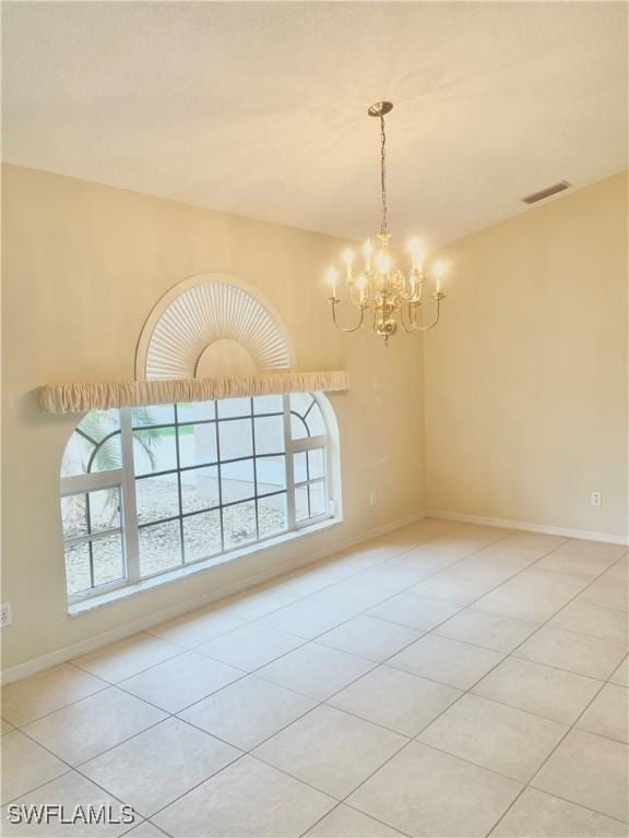 86 Pinehurst Pl, Rotonda West, FL 33947 - tiled empty room featuring a chandelier and baseboards
