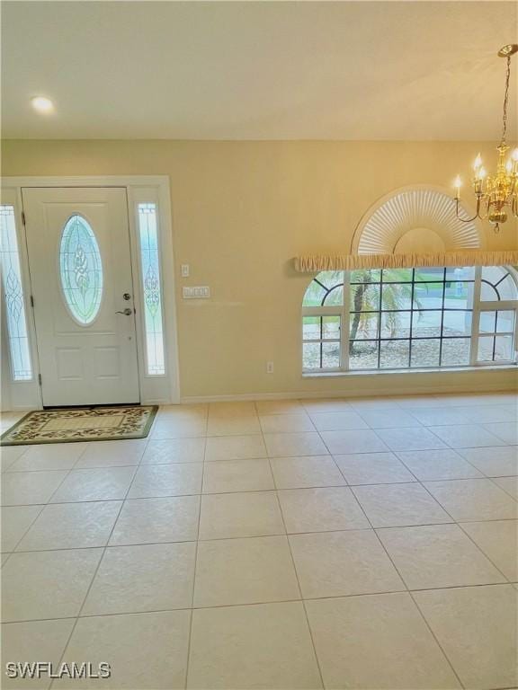 86 Pinehurst Pl, Rotonda West, FL 33947 - tiled foyer featuring a chandelier and baseboards