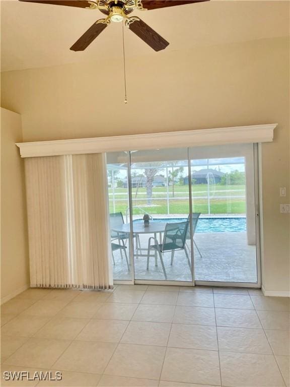 86 Pinehurst Pl, Rotonda West, FL 33947 - empty room with ceiling fan, light tile patterned flooring, and a towering ceiling