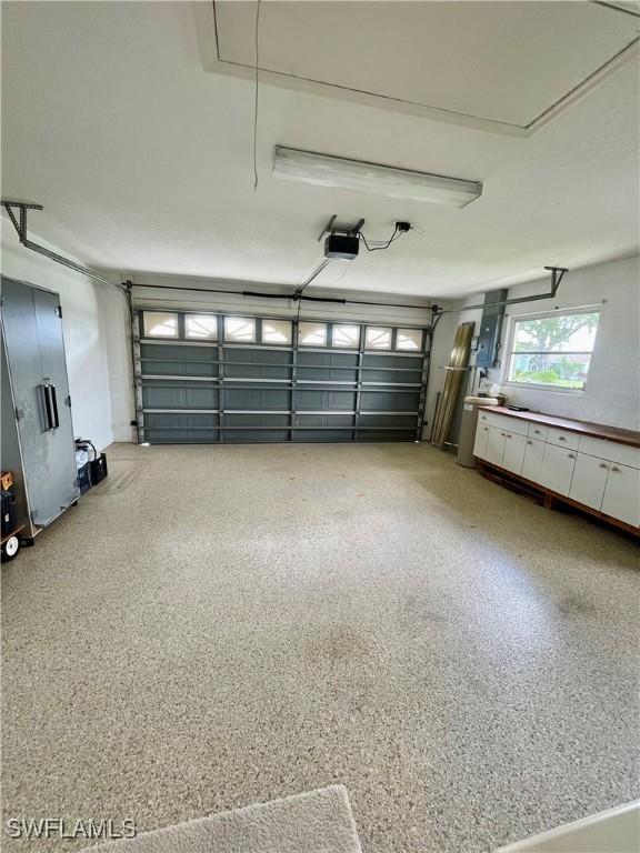86 Pinehurst Pl, Rotonda West, FL 33947 - garage with a garage door opener
