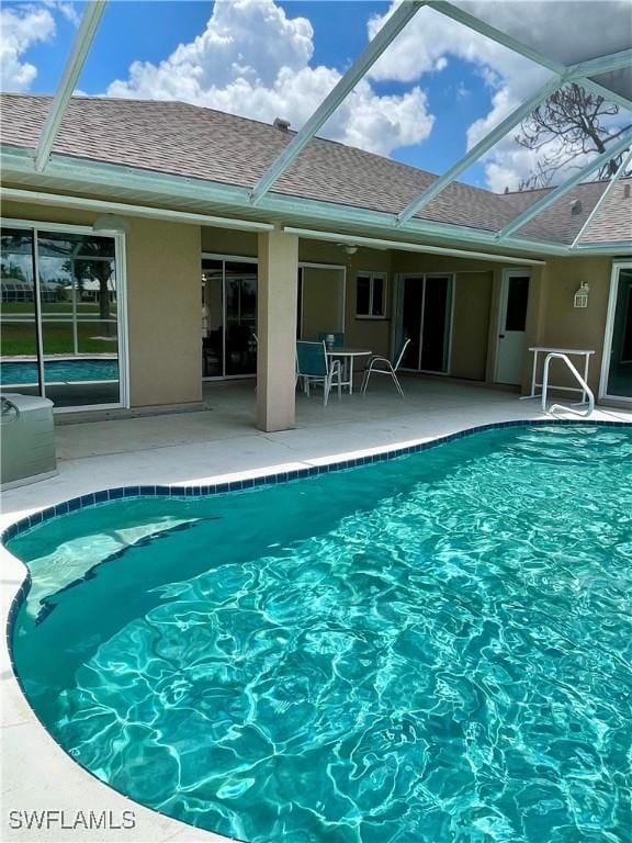 86 Pinehurst Pl, Rotonda West, FL 33947 - outdoor pool featuring glass enclosure and a patio area