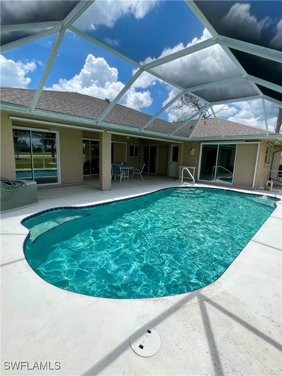 86 Pinehurst Pl, Rotonda West, FL 33947 - outdoor pool with a patio and glass enclosure