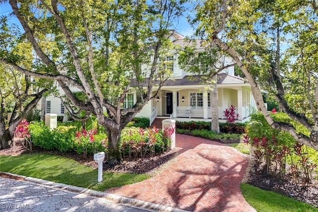1550 Gordon Dr, Naples, FL 34102 - view of front of house with covered porch and stucco siding