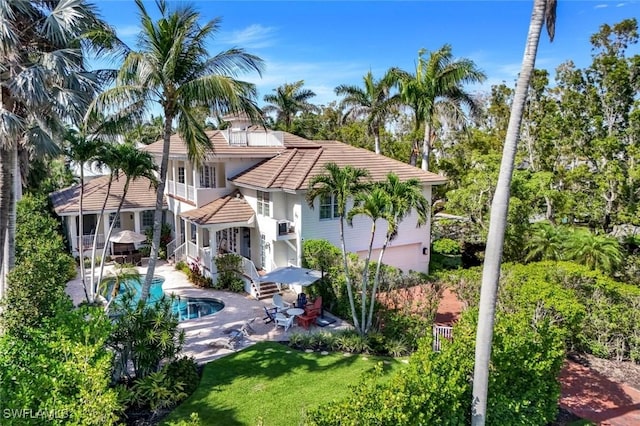1550 Gordon Dr, Naples, FL 34102 - back of property featuring a balcony, a tiled roof, a patio area, an outdoor pool, and a garage
