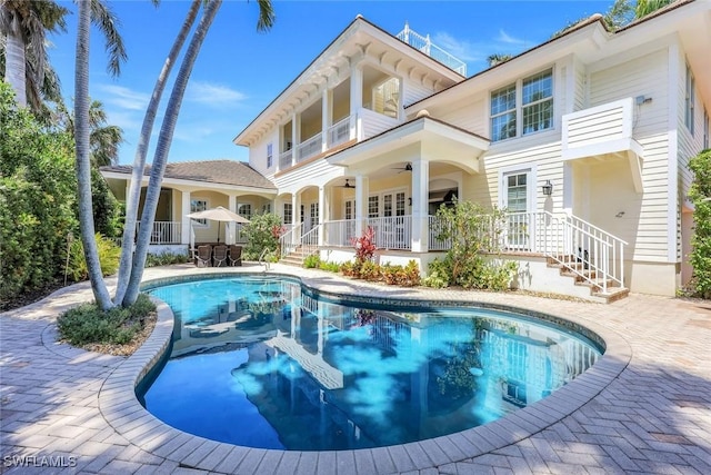 1550 Gordon Dr, Naples, FL 34102 - back of property featuring an outdoor pool, ceiling fan, and a patio