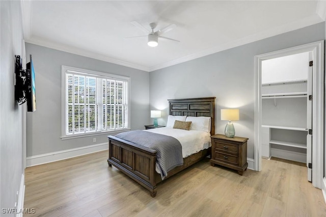 1550 Gordon Dr, Naples, FL 34102 - bedroom with light wood-style floors, ornamental molding, a walk in closet, baseboards, and a ceiling fan
