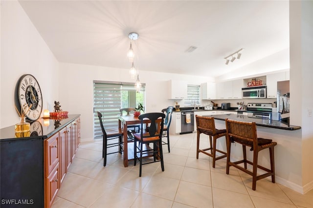 725 Grove Dr, Naples, FL 34120 - dining room featuring light tile patterned flooring and baseboards