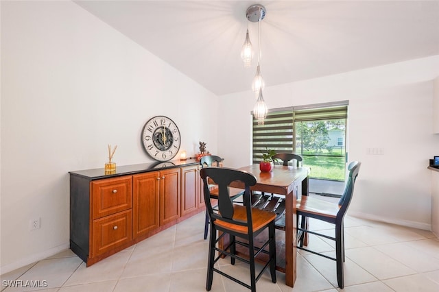 725 Grove Dr, Naples, FL 34120 - dining space with light tile patterned floors and vaulted ceiling