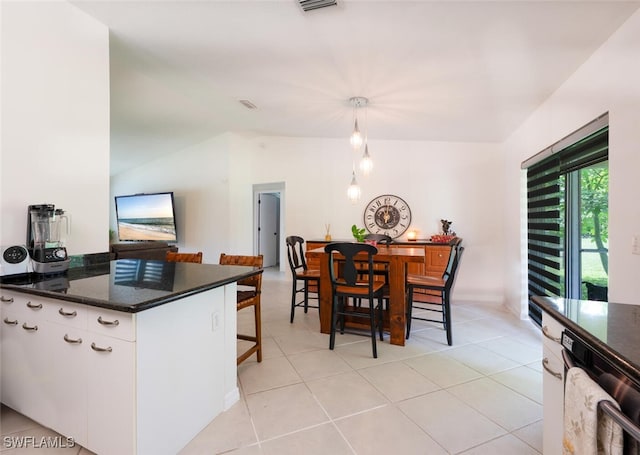 725 Grove Dr, Naples, FL 34120 - kitchen with black dishwasher, white cabinets, decorative light fixtures, and light tile patterned floors