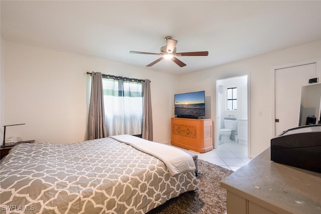 725 Grove Dr, Naples, FL 34120 - bedroom featuring light tile patterned floors, connected bathroom, and ceiling fan