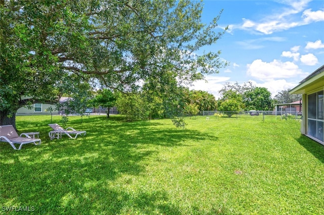 725 Grove Dr, Naples, FL 34120 - view of yard featuring a sunroom