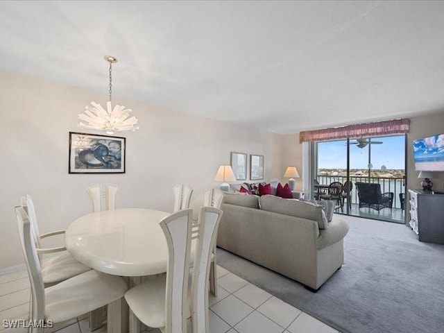 897 Collier Ct Unit 4-705, Marco Island, FL 34145 - dining area featuring a chandelier and light tile patterned flooring