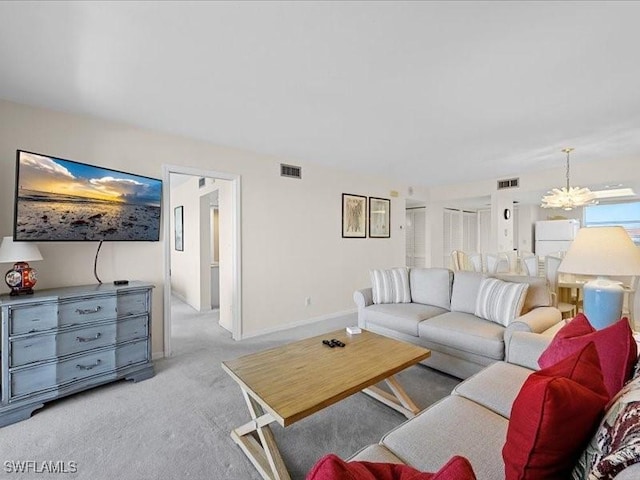 897 Collier Ct Unit 4-705, Marco Island, FL 34145 - carpeted living room featuring a chandelier and baseboards