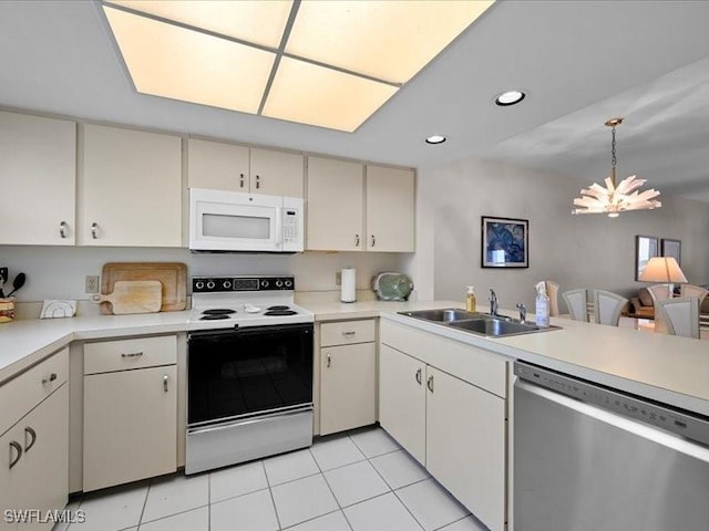 897 Collier Ct Unit 4-705, Marco Island, FL 34145 - kitchen with white appliances, a sink, light countertops, a chandelier, and recessed lighting