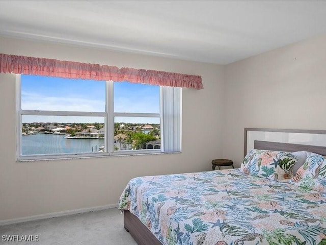 897 Collier Ct Unit 4-705, Marco Island, FL 34145 - bedroom featuring carpet, multiple windows, baseboards, and a water view