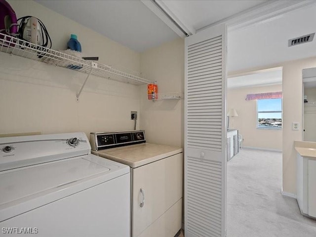 897 Collier Ct Unit 4-705, Marco Island, FL 34145 - laundry room featuring washing machine and dryer and light carpet