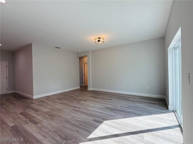 unfurnished room featuring wood finished floors and baseboards