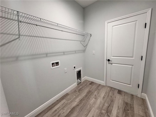 washroom featuring washer hookup, wood finished floors, hookup for an electric dryer, and baseboards
