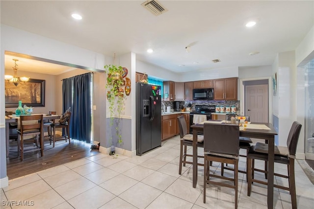 221 Paine Dr, Winter Haven, FL 33884 - dining room with baseboards, light tile patterned flooring, a chandelier, and recessed lighting