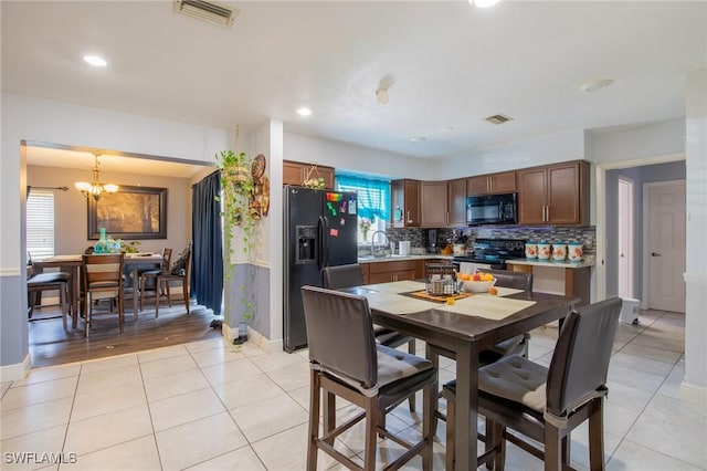 221 Paine Dr, Winter Haven, FL 33884 - dining space with light tile patterned floors, a chandelier, baseboards, and recessed lighting
