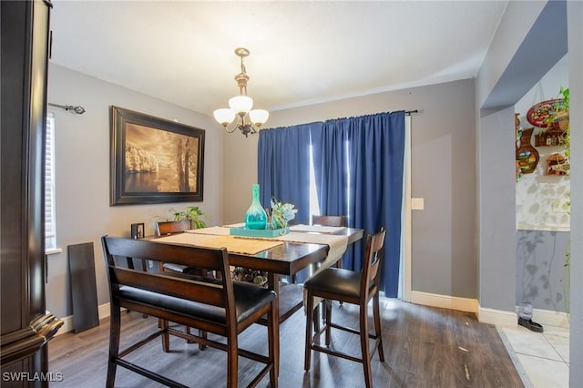 221 Paine Dr, Winter Haven, FL 33884 - dining space with a chandelier, wood finished floors, baseboards, and healthy amount of natural light