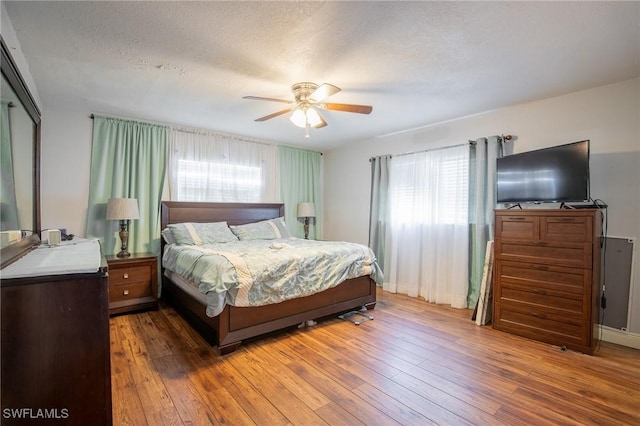 221 Paine Dr, Winter Haven, FL 33884 - bedroom featuring hardwood / wood-style flooring, a ceiling fan, and a textured ceiling