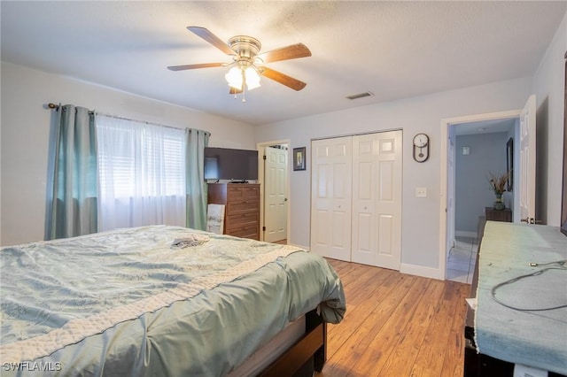221 Paine Dr, Winter Haven, FL 33884 - bedroom with light wood-style flooring, a closet, a ceiling fan, and baseboards